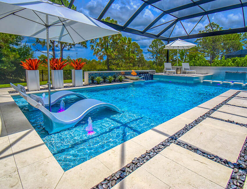 Screened-in Florida pool with floating loungers and umbrellas